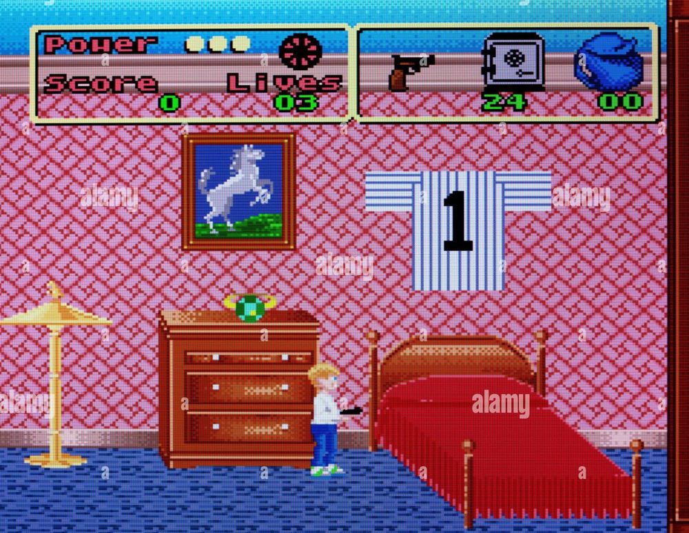 screen from Home Alone (SNES) with a tiny kevin in a bedroom with giant red bed and dresser and lamp. theres a big emerald ring on the dresser above kevin. in the game he's trying to secure valuables from the robbers by platforming jumping from the bed to a dresser etc and dropping the stuff you found in the safe to end the level. it sucks extremely bad, AND the music stuck in my head now. theres alamy watermarks all over the picture for some reason