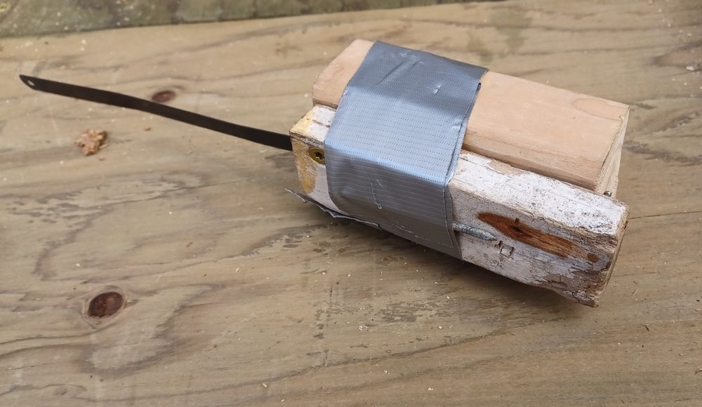 an improvised hand saw with a hacksaw blade between a block of wood and a tiny piece of cut off lumber dunnage screwed together, and a nail driven thru the saw blade hole to keep it in place. fuck it we ball