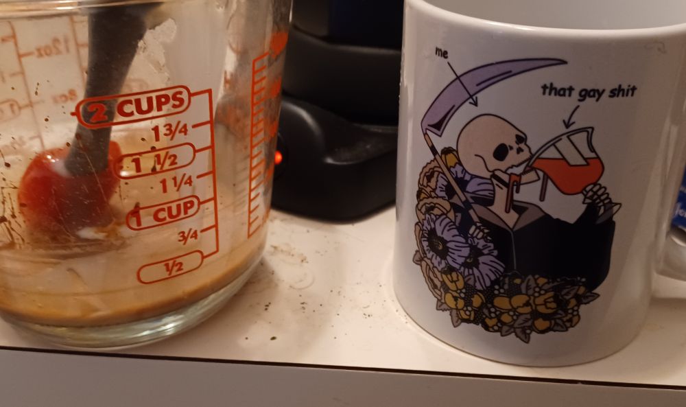 pyrex with mocha base, moka pot full of espresso, a mug with a skeleton labeled "me" drinking a chalise labeled "that gay shit"  ko-fi.com/magentaskull