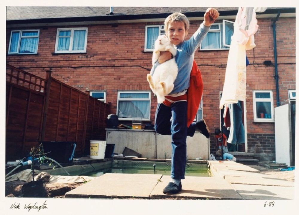 Morning all.
Photograph by Nick Waplington.
Untitled from the series Living Room. 1980s.
 A young boy strikes a ‘Superman’ pose holding a large white rabbit. The boy has red pants over his trousers and a red jumper fastened to his back like a cape.