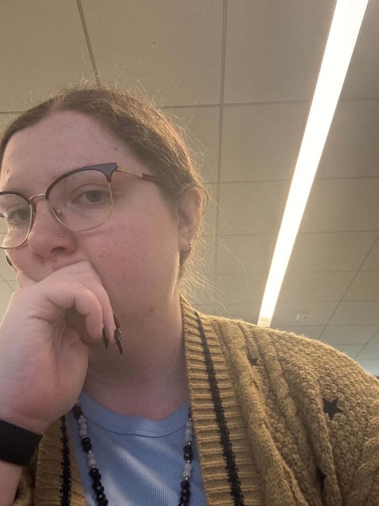 a selfie of Jess. she’s wearing the Fearless Cardigan and a pale blue tank top