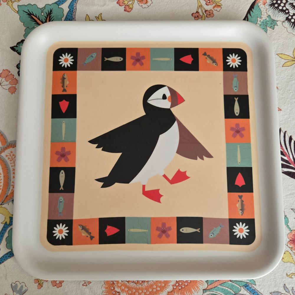 Melamine tray with a central image of a puffin and a border with images of fish and flowers, all very pleasingly colored and arranged.