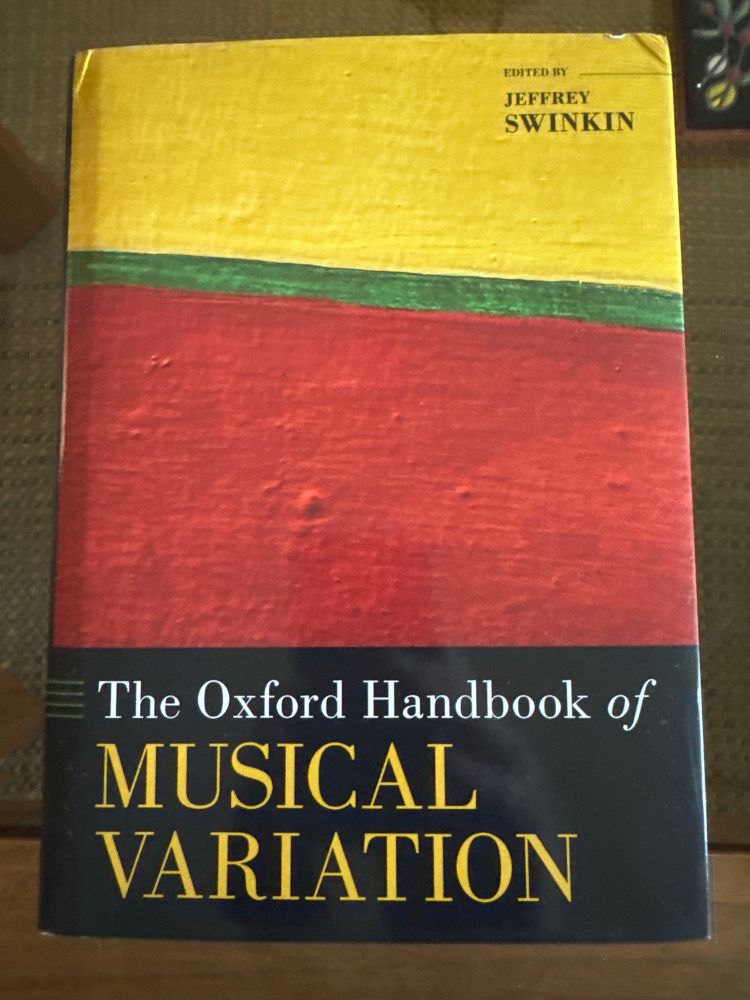Cover of Oxford Handbook of Musical Variationy. The image is a shutterstock picture of a painting, a wide band of yellow, then a narrow band of green, and an even wider band of red, all tilted at an angle. A black band with the title overlaid in white and yellow is at the bottom 