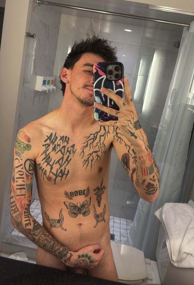 Tattooed English gay guy taking a selfie in a bathroom on the Vegas Strip