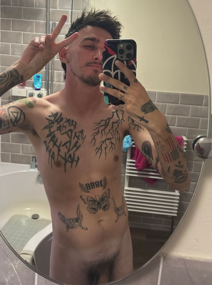 Some fucking poser covered in tattoos making a peace sign