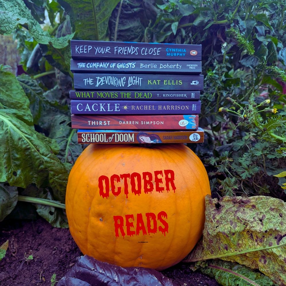 An orange pumpkin sat on the ground outside, with a stack of paperback books on top of it. Behind the pumpkin is assorted veg garden foliage. 
The books are School of Doom by Sarah Harrison (would love to read a sequel, fingers crossed there'll be one coming) Thirst by Darren Simpson, Cackle by Rachel Garrison (read for the Poisoners Cabinet podcast book club, then totally forgot to log on for the zoom meeting) What Moves the Dead by T. Kingfisher, The Devouring Light by Kat Ellis, The Company of Ghosts by Berlie Doherty, and Keep Your Friends Close by Cynthia Murphy. 
This is the most books I've read in a month for years, I think it's because I've changed schedule and now have 3 hours a week on a bus. Brilliant for getting a lot of books read!