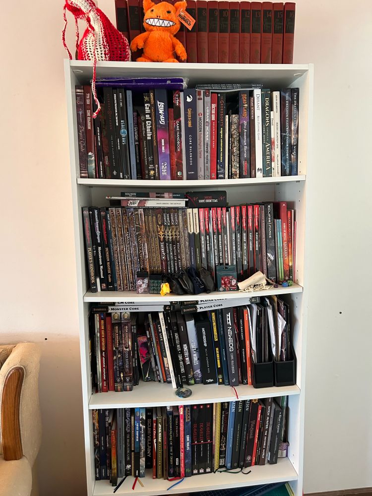 A bookshelf full of TTRPG game books. 