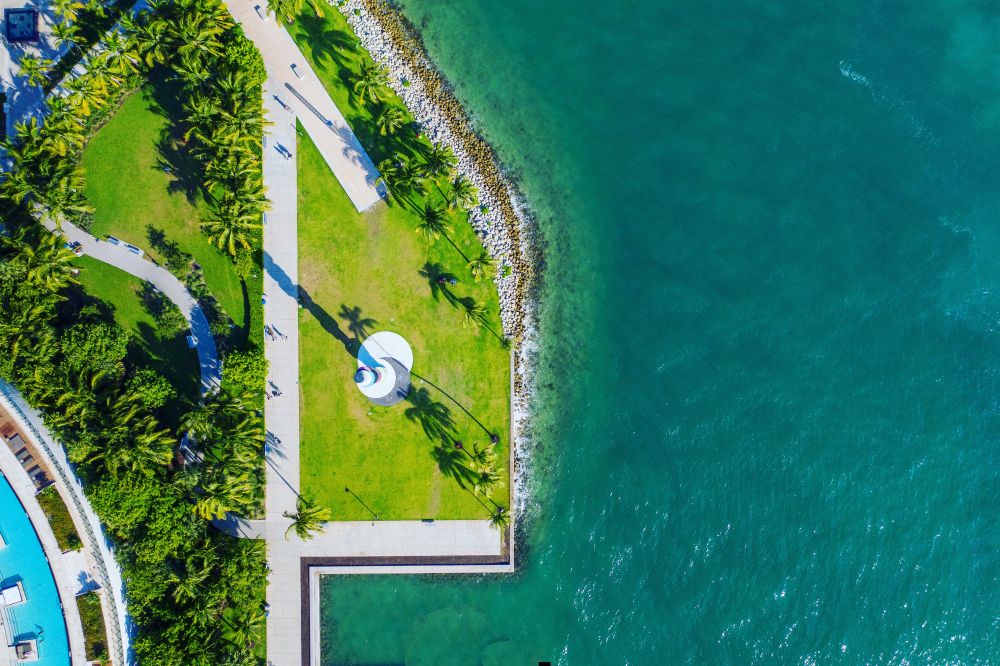 Photo 1 (Waterfront park):
Drone shot of South Pointe Park in Miami Beach, Florida, showing the colorful circular pier sculpture, palm-lined walkways, and turquoise waters of the Atlantic Ocean.