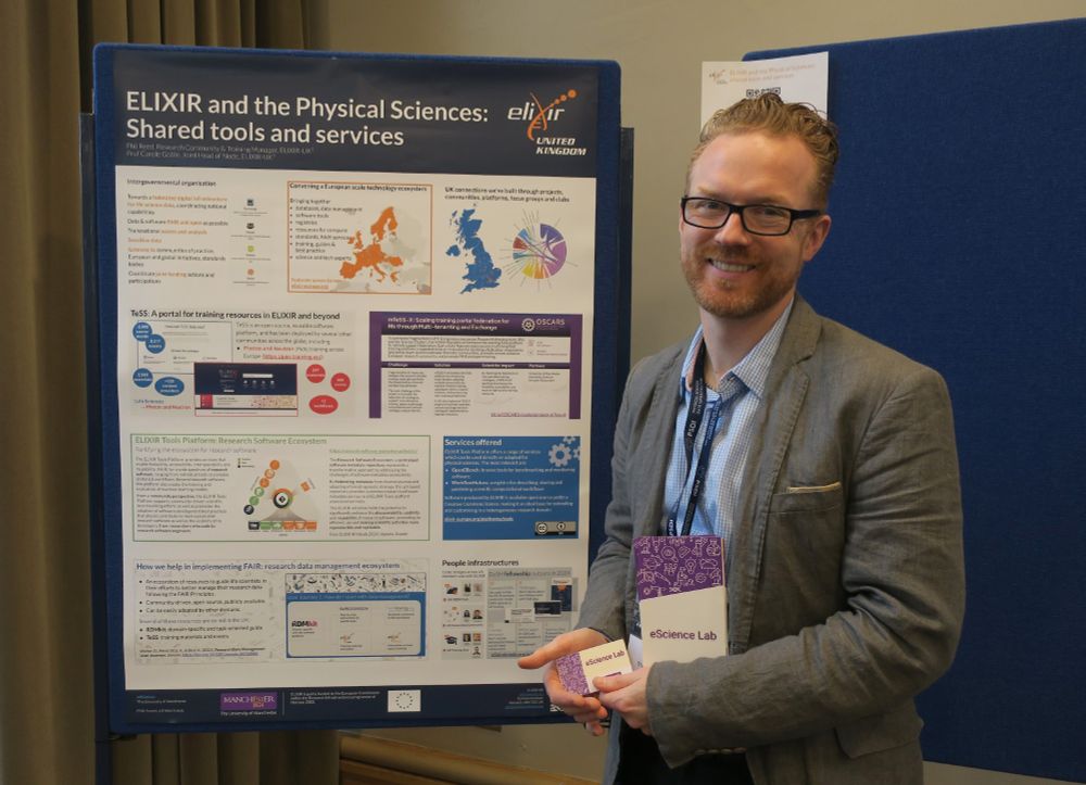 Phil stood in front of the poster presentation
