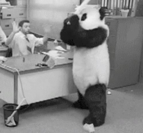 Person wearing a panda bear costume smashing a keyboard