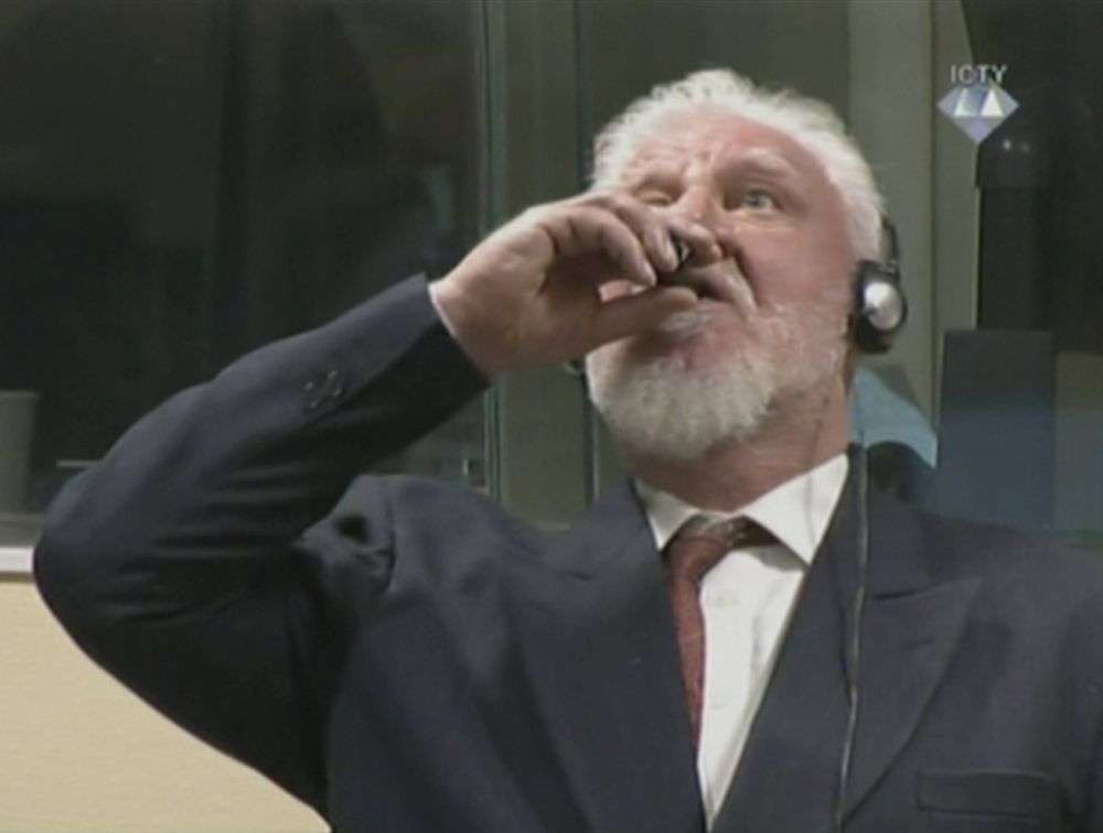 bosnian croat war criminal slobodan praljak drinking a vial of poison in a pose reminiscent of those of rfk jr and paul saladino in the photo of the quoted post.