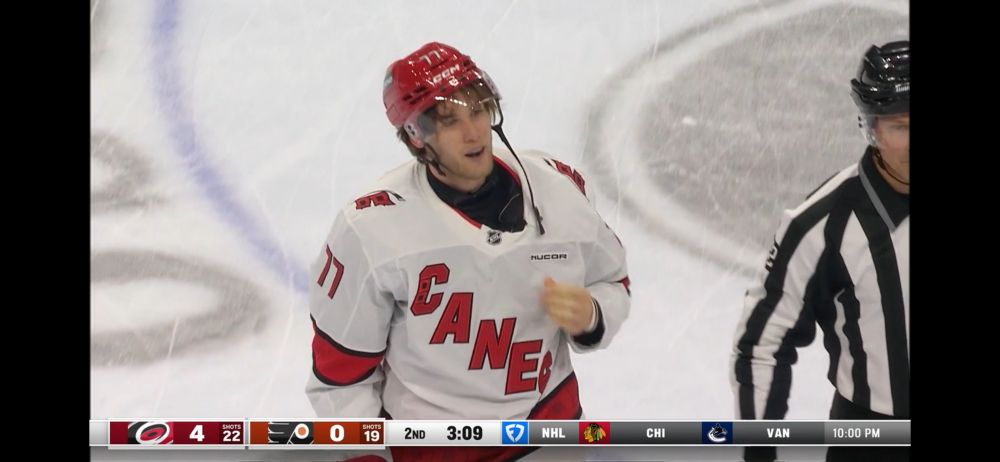Mark Jankowski skating toward the penalty box with his helmet pushed up a lil 