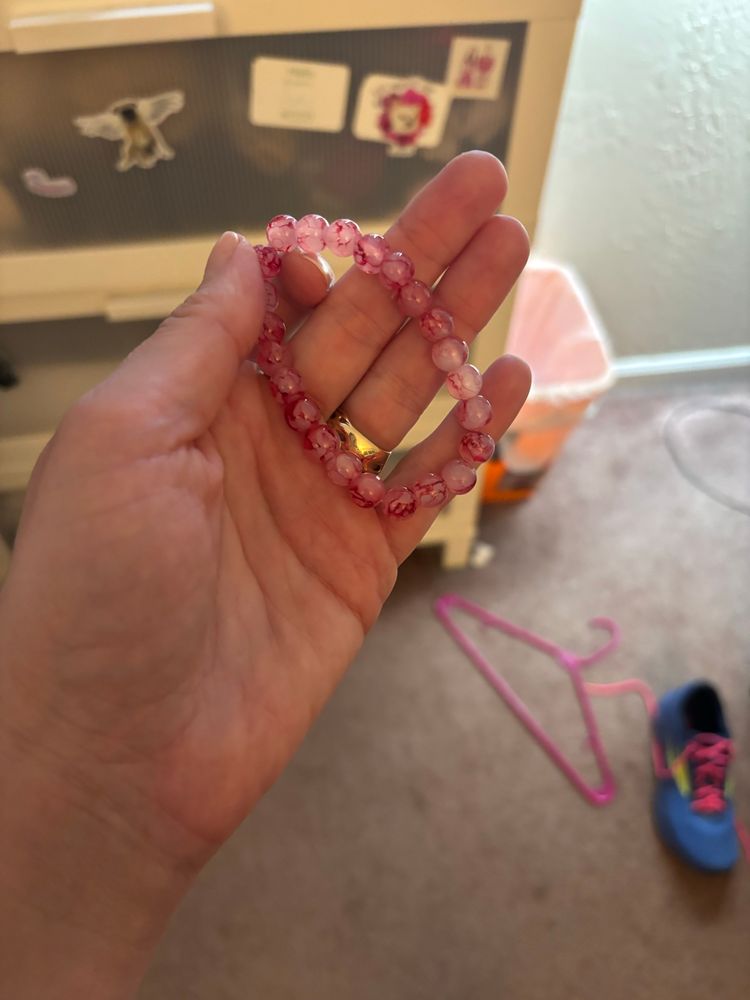 A pink beaded bracelet a Poshmark seller gave me against my will