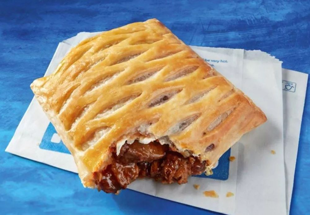 a picture of the greggs steak bake on top of a greggs paper bag.