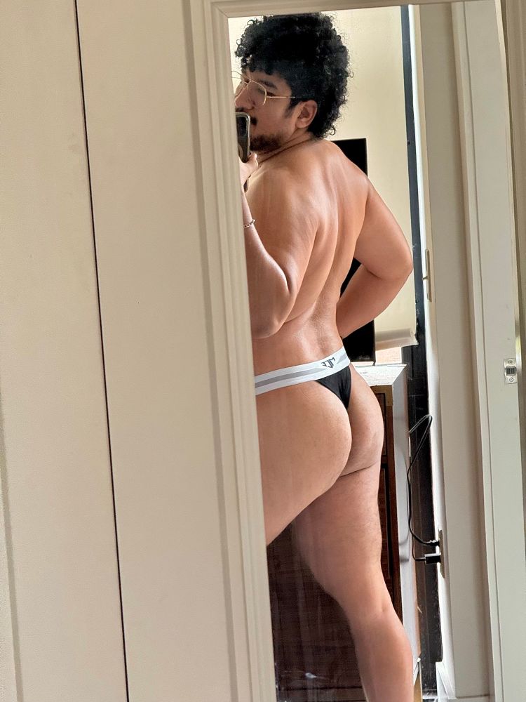 Mirror selfie of backside in black thong