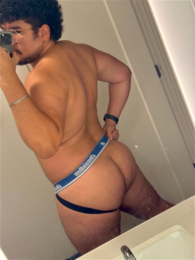 Mirror selfie of backside wearing a black and blue jockstrap