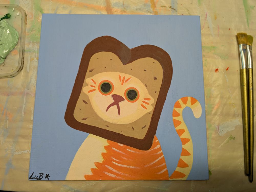 Photo d'une peinture sur toile représentant un chat la tête coincée dans un toast
