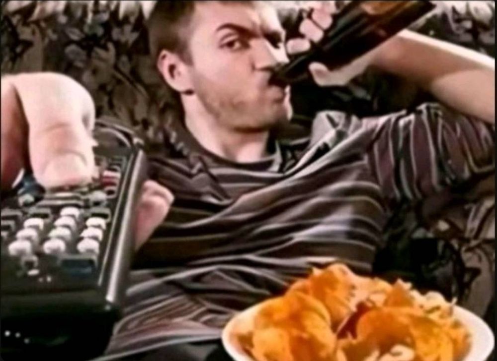 The meme of the guy drinking a beer, with the remote and bbq chips on his lap. 