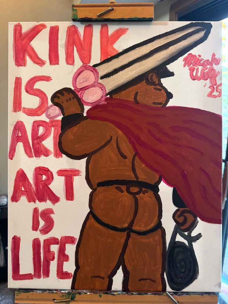 A burly bear wearing a cape, a daddy hat and a jockstrap is holding a sword with the hilt shaped like a dildo with big balls, and holding a whip in his other hand. Beside him is a message that reads “Kink Is Art, Art Is Life”. 