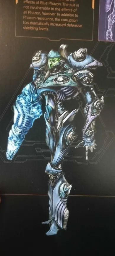 Another early take on the Phazon Suit, this time with a striking black, silver, and indigo color scheme. The metal plating has taken on a decayed, corpse-like appearance in portions. Samus's face is visible through the visor, with deeply sunken eyes.