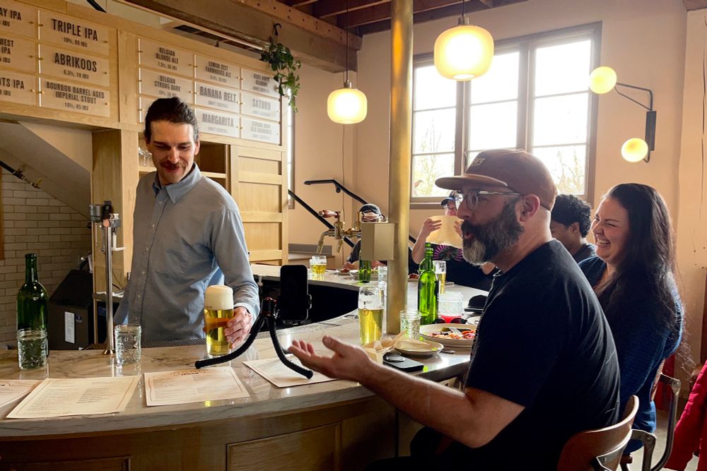 A bartender offers a beer at the new pFriem Family Brewers. 