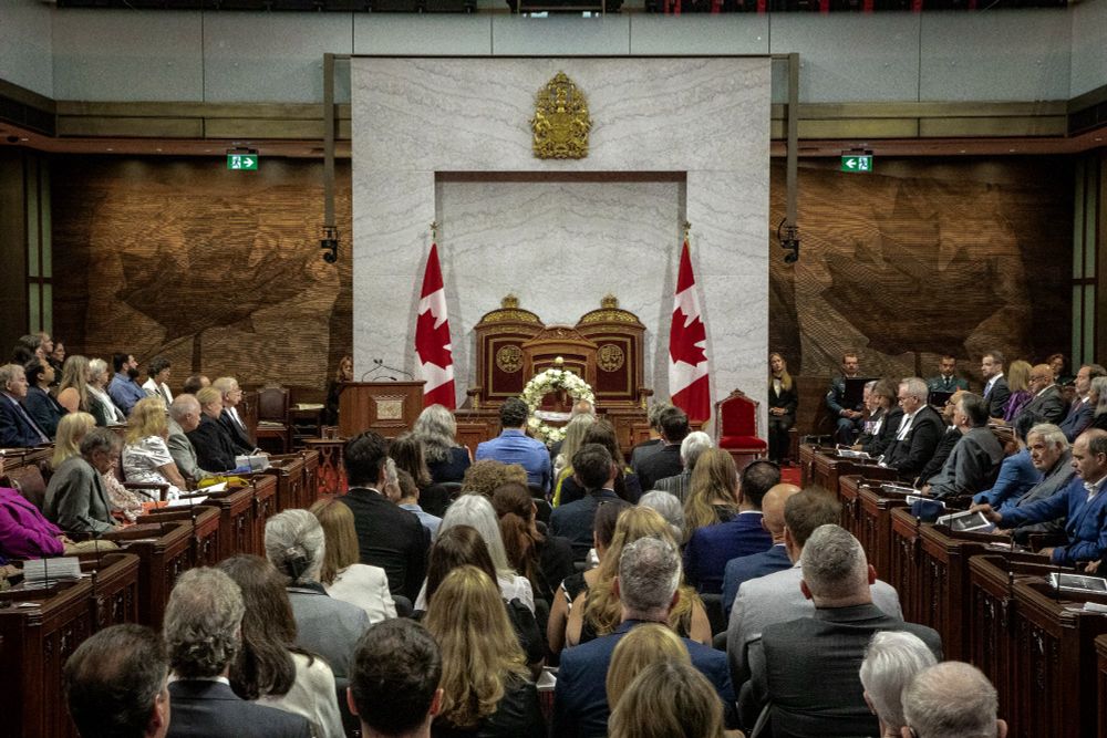 The Senate Chamber with a wreath at its center, as dignitaries and guests pay tribute to the late parliamentarians.