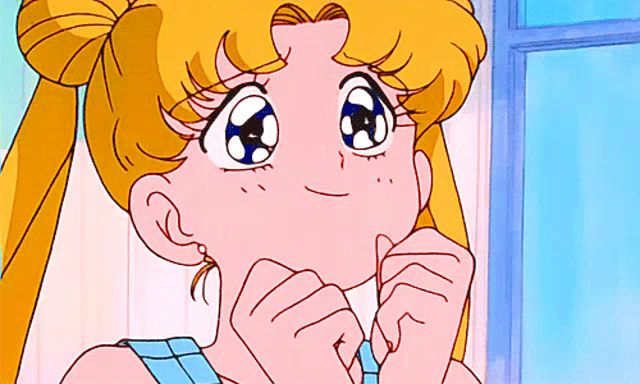 a cartoon girl with blonde hair and blue eyes is smiling with her hands on her face