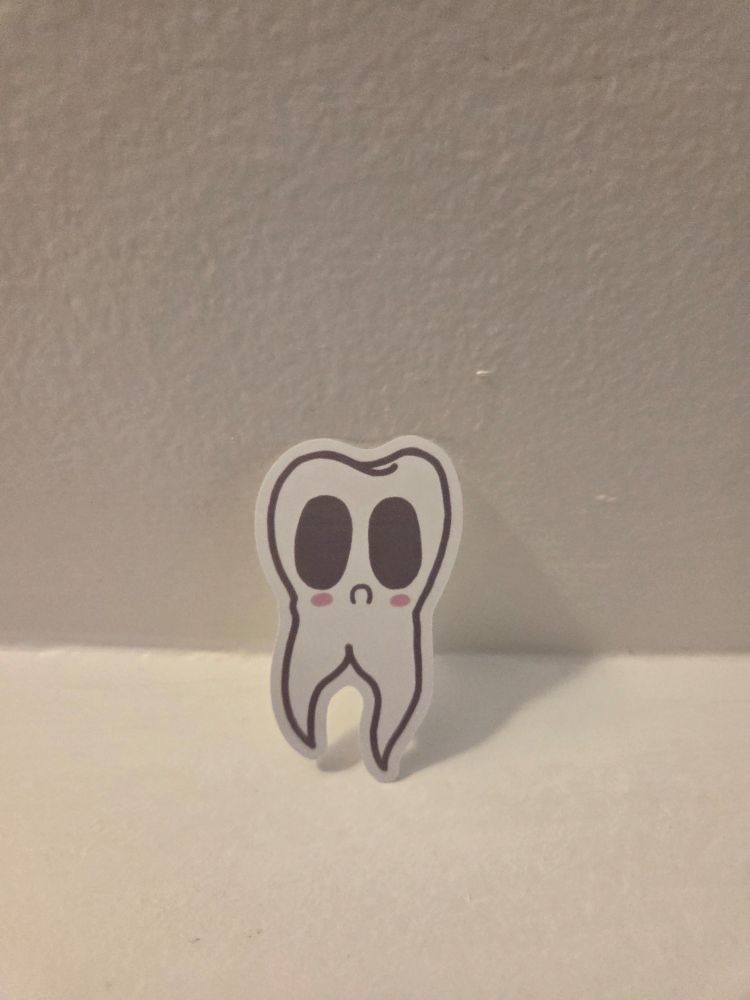 Teethling: a cute little tooth friend with a sad face 