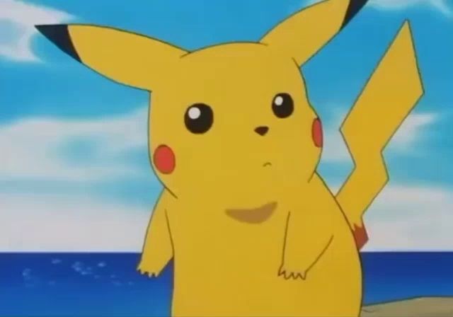 a cartoon pikachu is standing on a beach with a star in the background .