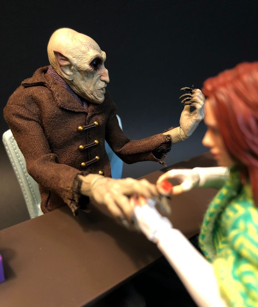 Nosferatu is seated and getting a manicure. His nails are fabulous. Toy photo