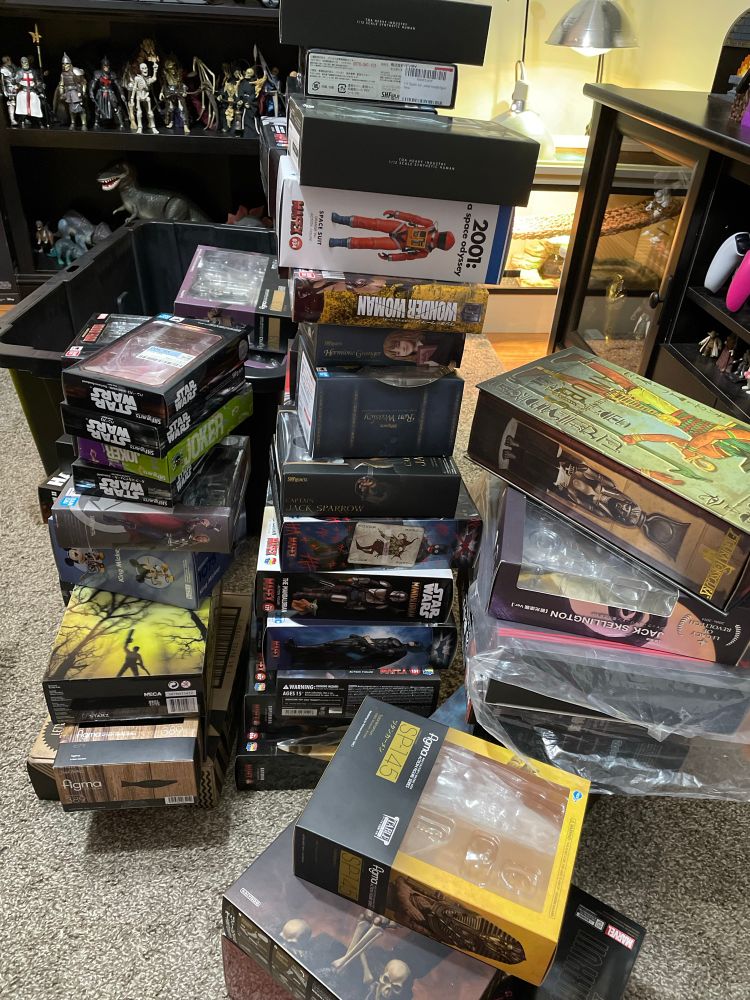 A small portion of the action figure boxes that had been stashed in my closet, stacked up on the floor.