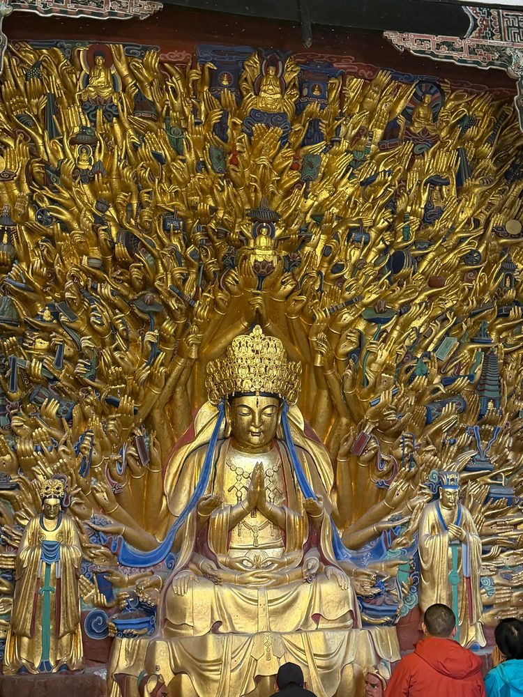 The Avalokitesvara with Thousand hands, a golden figure engaged in prayer with many many golden hands behind and around it. A nearby plaque describes it as follows: 

Avalokitesvara with Thousand hands
No.8, A.D. 1174-1252
This niche, 770cm high, 1250cm wide, houses 72 statues and 126 different implements.
The
Avalokitesvara has indeed 1007 hands and in each palm there is an eye. The thousand hand spread on the cliff surface of 88 square meters like a peacock displaying its glittering open tail.
This niche is reputed “a spectacular in the
world.”