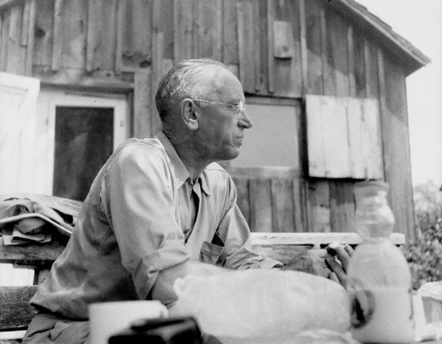 Aldo Leopold, one of the first US foresters and one of the fathers of ecological science, sitting in front of his shack in Wisconsin's sand counties.
Pcture probably taken in the early 1940s.
Leopold died near here in 1949, while fighting a grassfire on a neighbor's property.