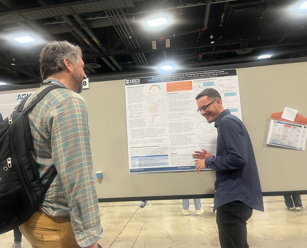 Max Schneider presenting a science poster in front of other scientists. 