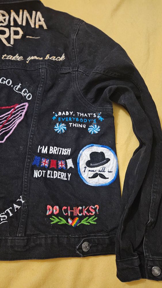A close up of the right hand side of the denim jacket. 