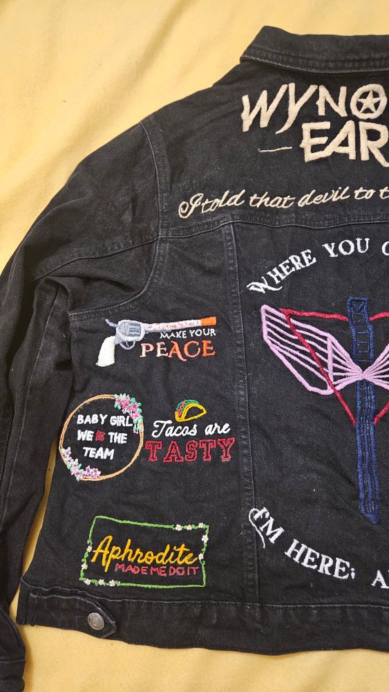 A close up of the embroidery on the left hand side of the denim jacket. 