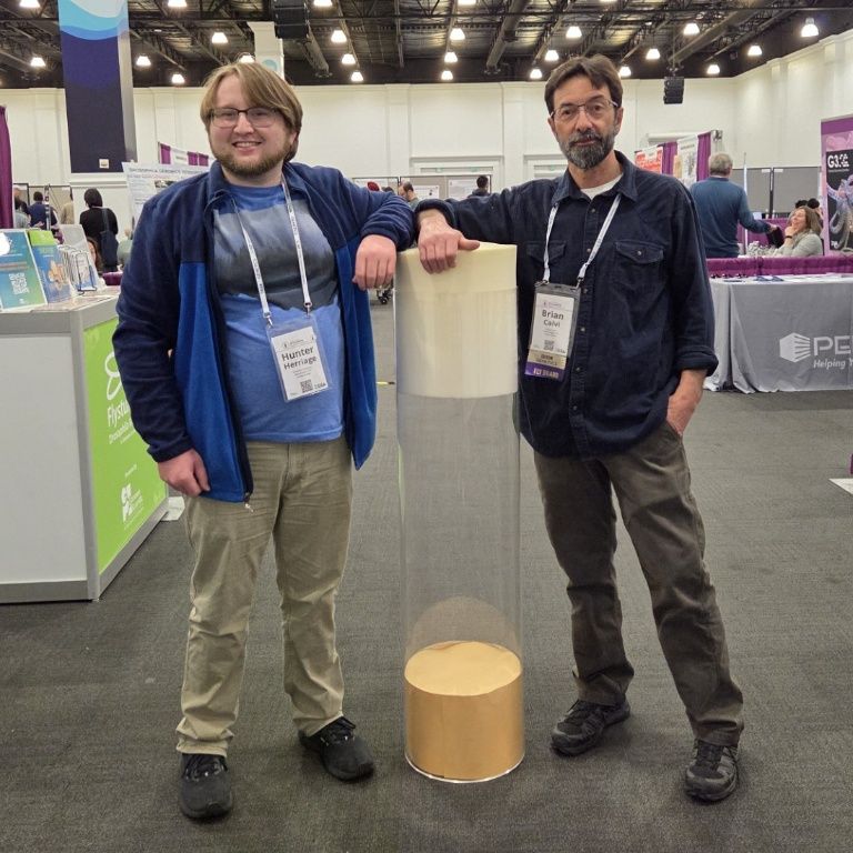 Hunter and his thesis mentor, Prof. Brian Calvi, next to a giant fly vial at the annual fly meeting.