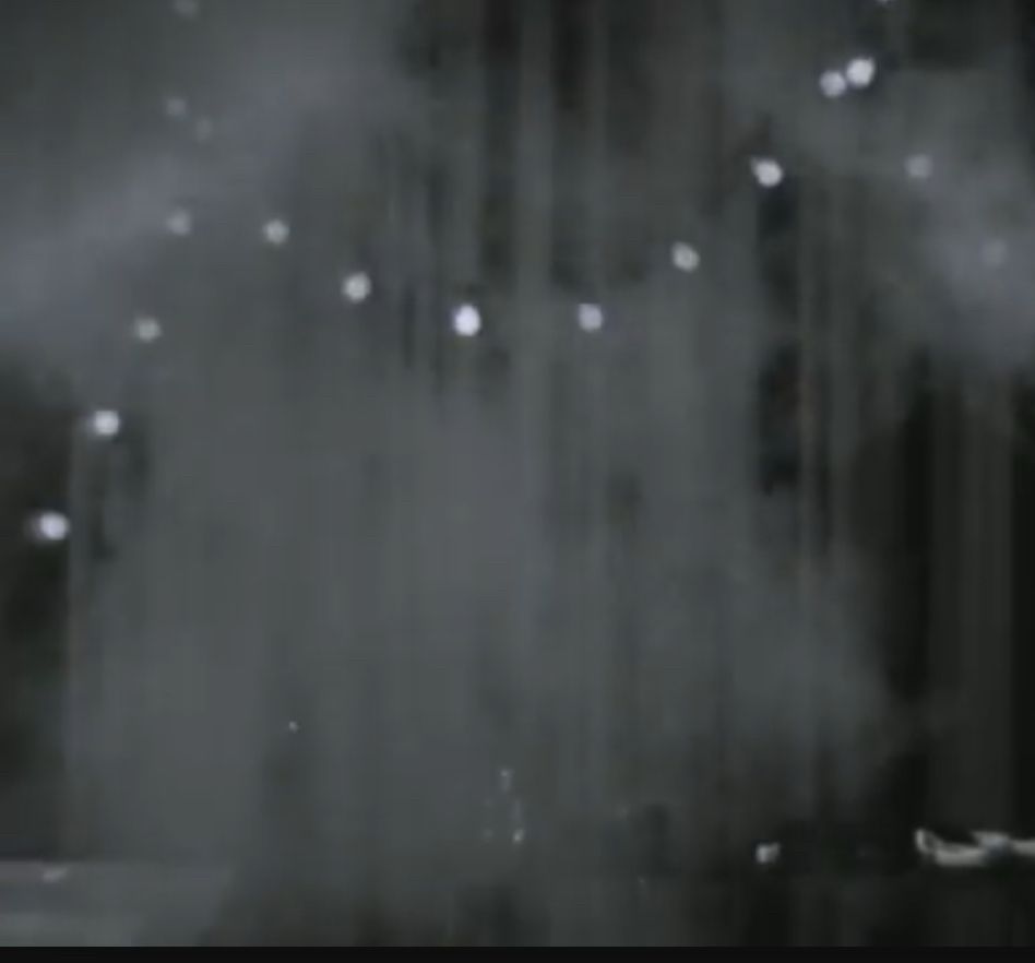 Picture #2 - Puff of smoke in front of a string of lights and a curtain 