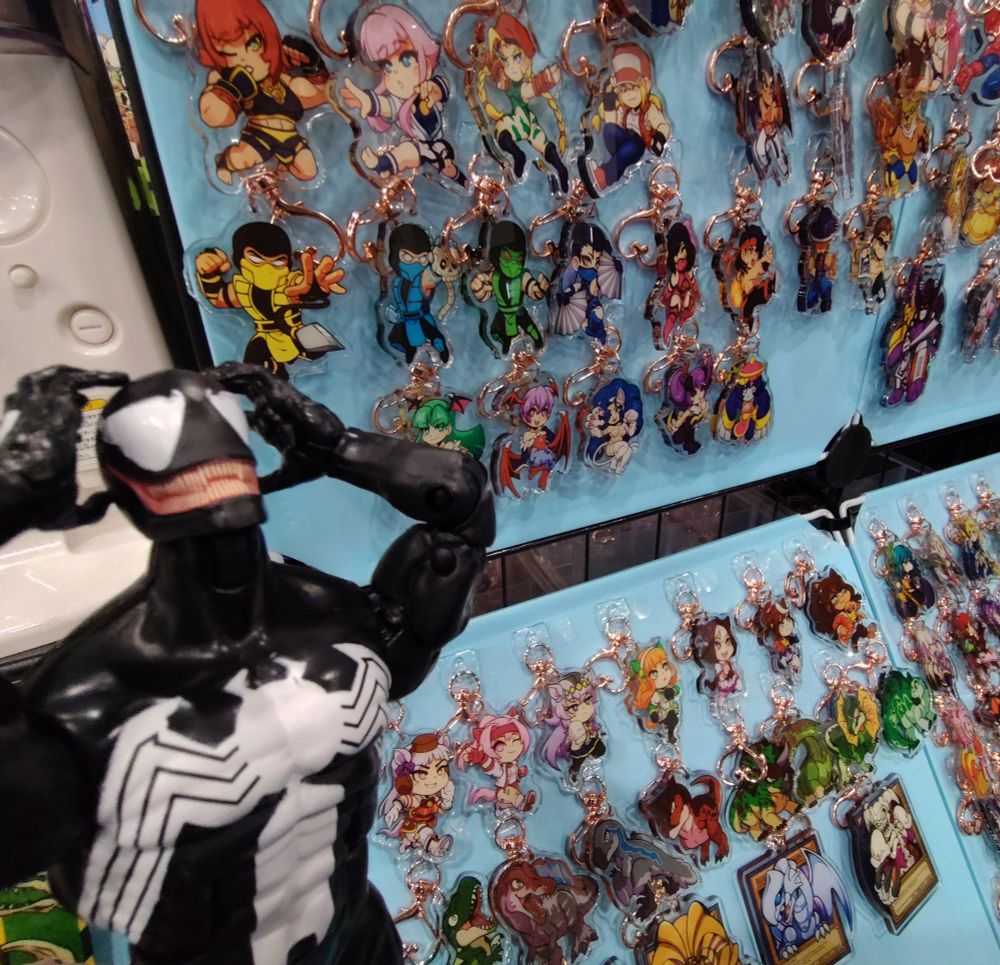 Venom in front of several keychains