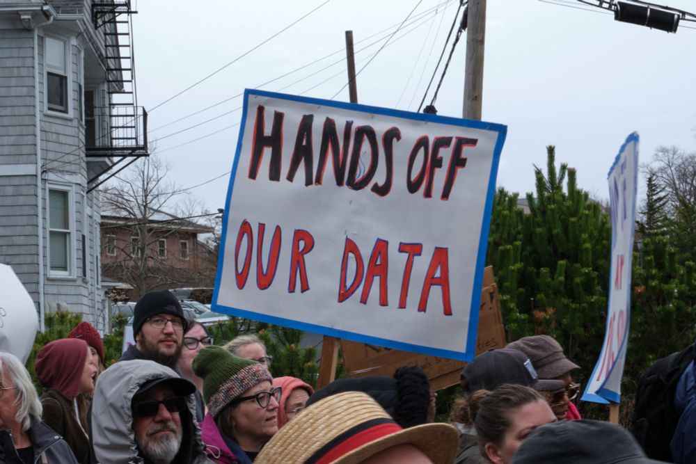 Photo from a #handsoff rally of a sign that says "Hands Off Our Data"