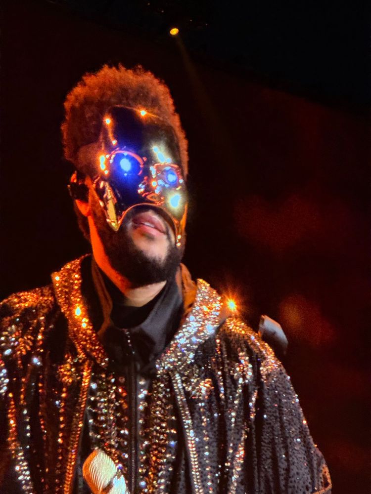A man with a mask on that has glowing eyes
