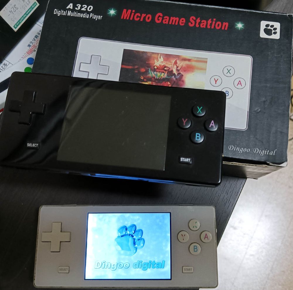 A black Dingoo A320 next to my old white one