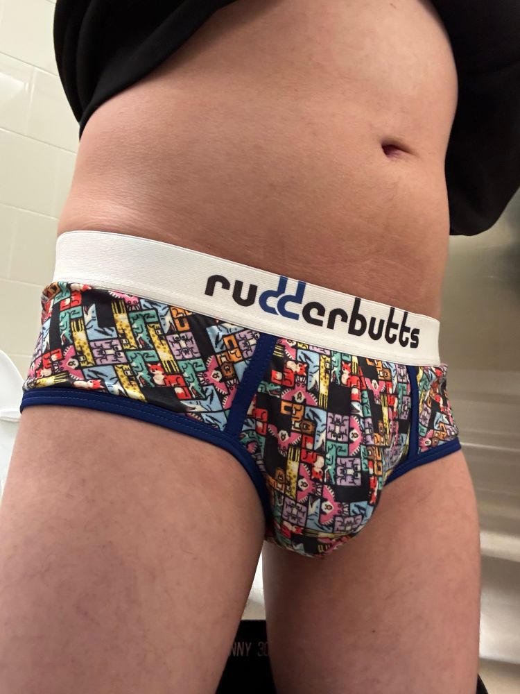 Clothes lifted and pants slid down to show underwear from front and backside