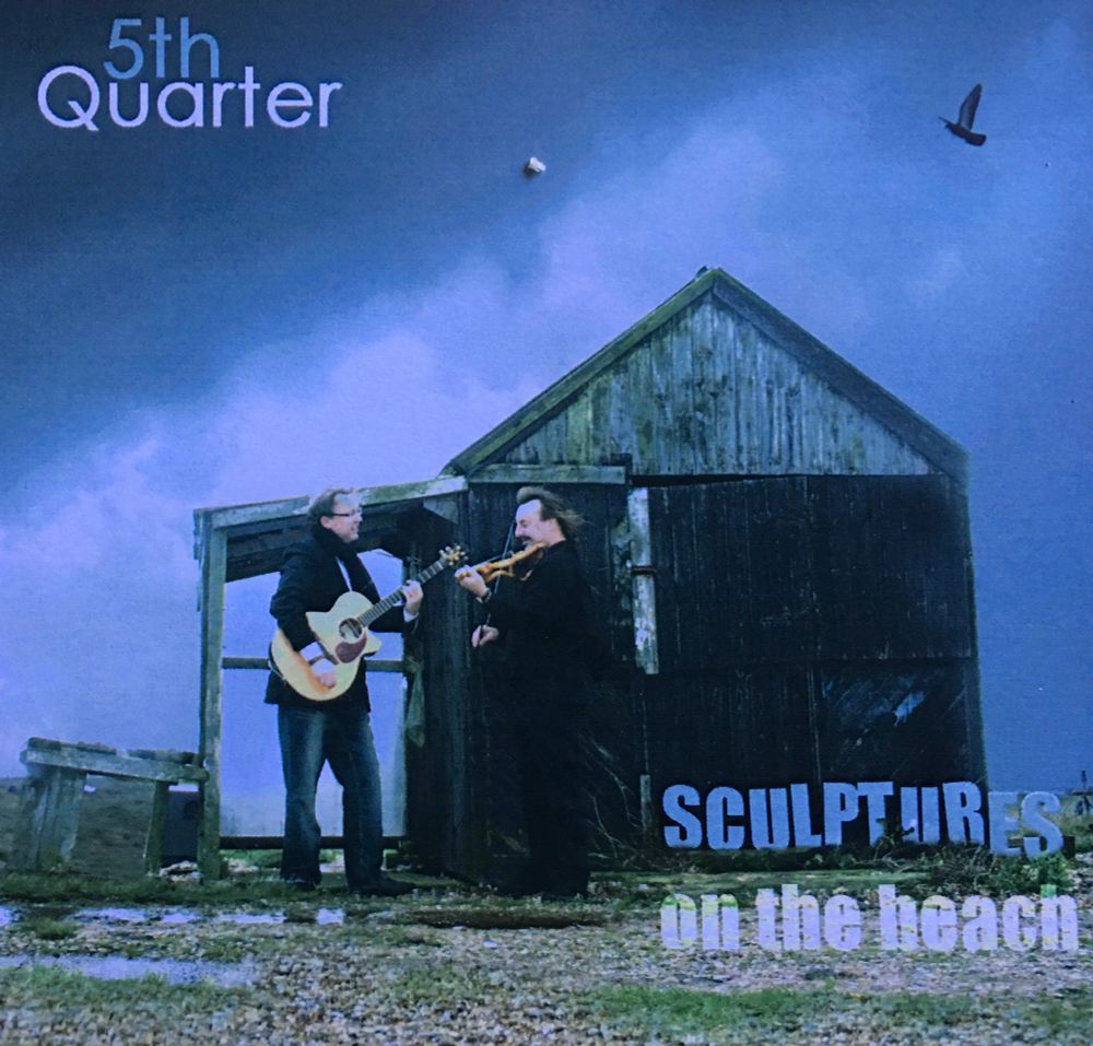 Folk Duo “5th Quarter” album cover “Sculptures on the Beach” showing guitarist and fiddler in front of a derelict wooden fisherman’s hut on Dungeness Beach