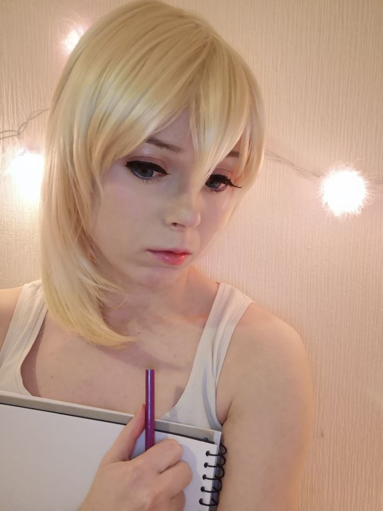 A cosplayer is cosplaying a character called Naminé from Kingdom Hearts series.