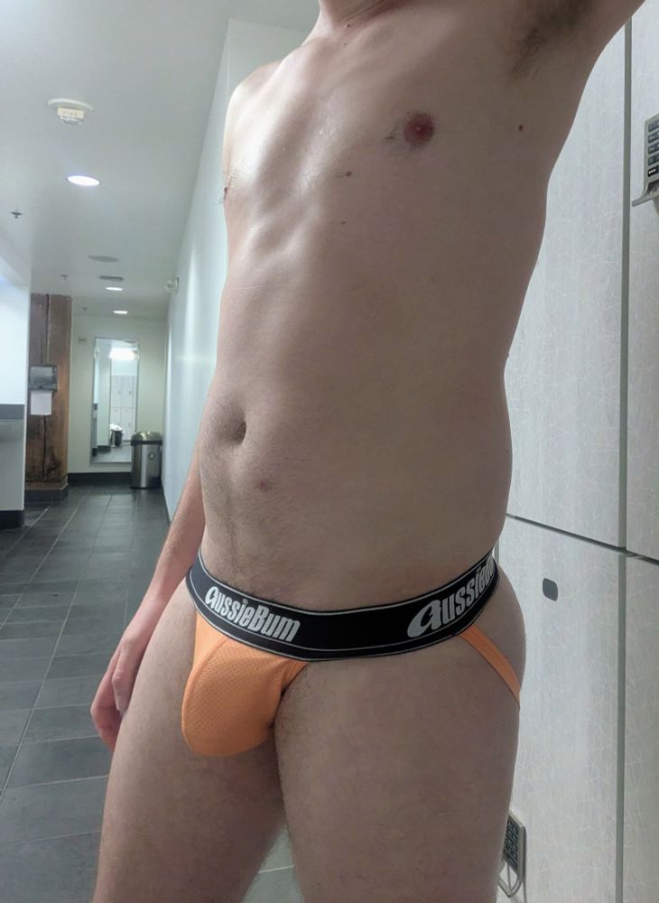 Ben selfie in locker room in orange Aussiebum jockstrap with bulge 
