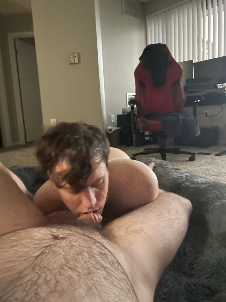 Naked slaveboy kissing his master's cock
