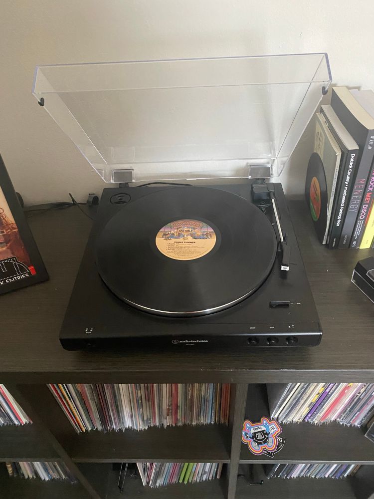 12” black vinyl disc sitting in a record player 