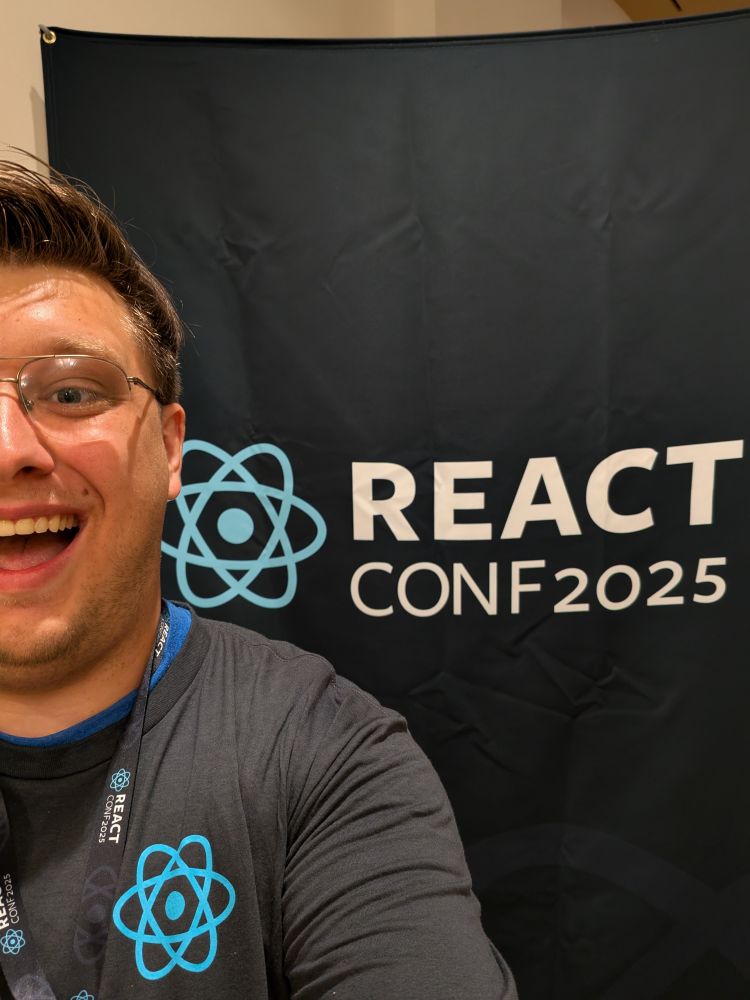 Myself in front of a React Conf banner