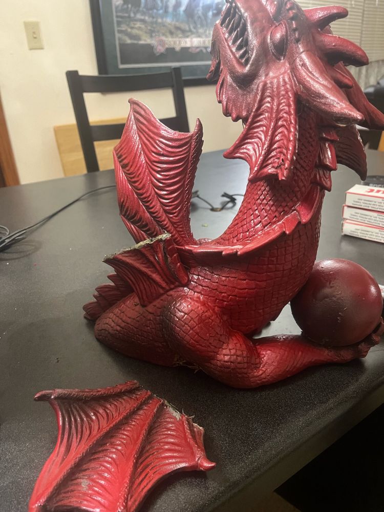 A red dragon with a broken wing